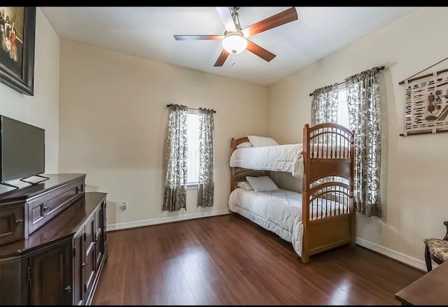 bedroom with dark hardwood / wood-style floors and ceiling fan