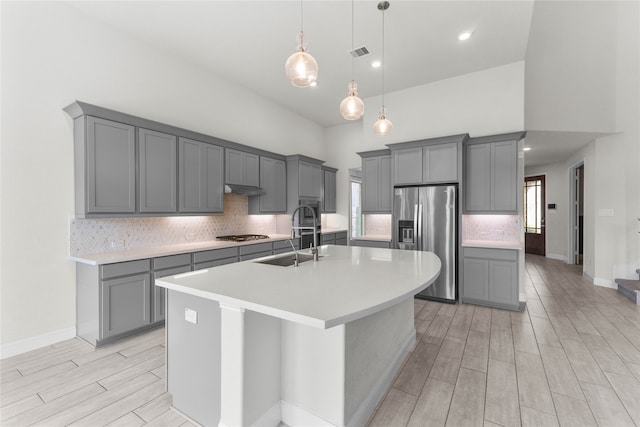 kitchen featuring stainless steel appliances, gray cabinets, and sink