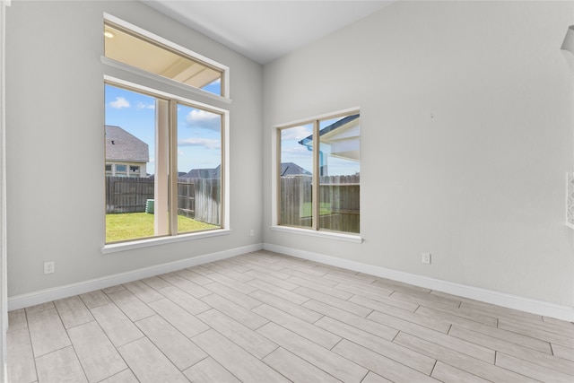 unfurnished room with light hardwood / wood-style floors and a wealth of natural light