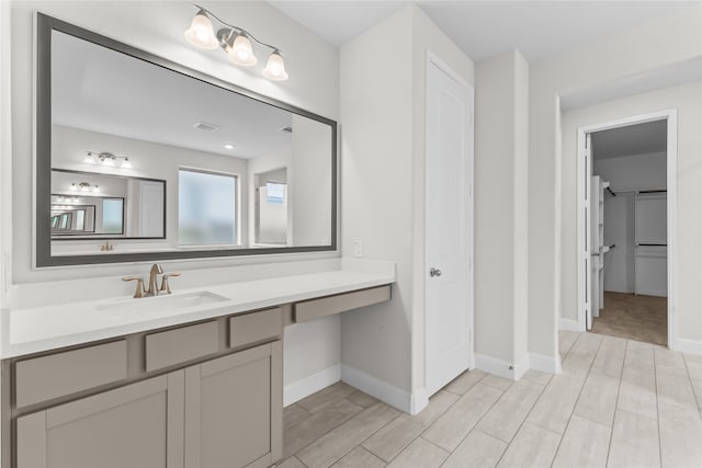 bathroom with hardwood / wood-style floors and vanity