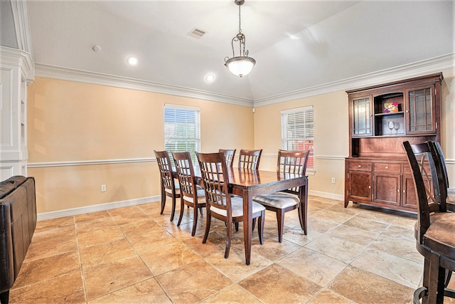 dining space with lofted ceiling and crown molding