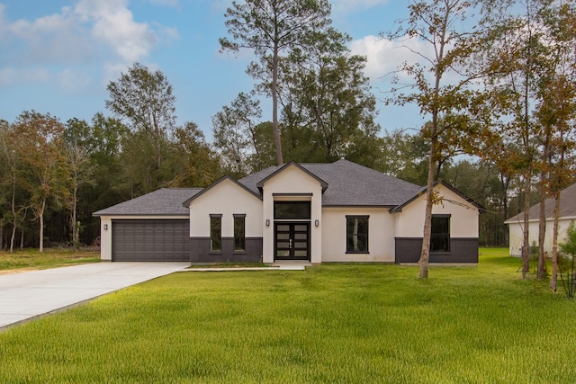 view of front of property featuring a front yard and a garage