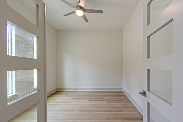 empty room featuring ceiling fan and light hardwood / wood-style flooring