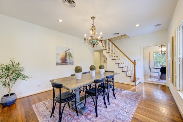 dining area featuring a notable chandelier and hardwood / wood-style flooring