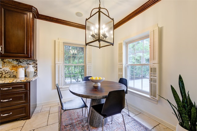 dining area with light tile patterned floors, a notable chandelier, and ornamental molding