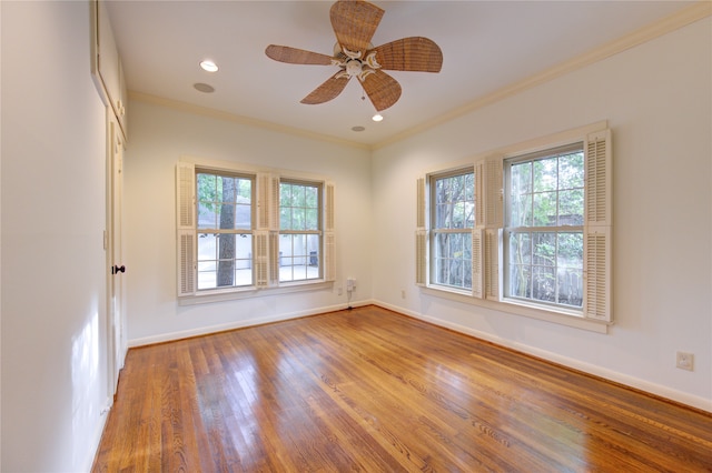 empty room with ceiling fan, wood-type flooring, and ornamental molding