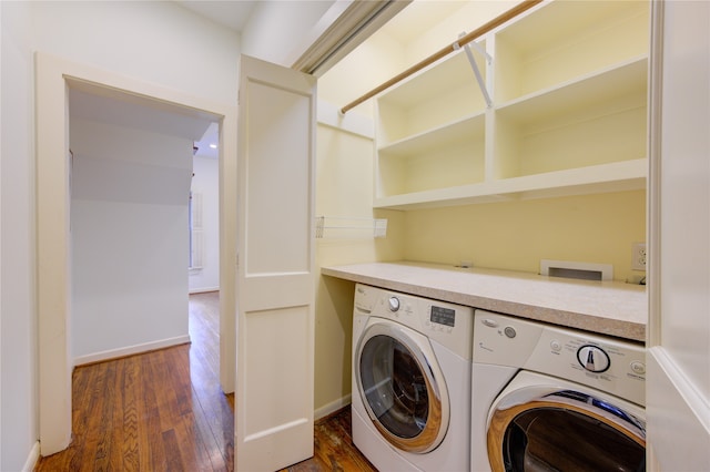 laundry area with dark wood-type flooring and washing machine and clothes dryer