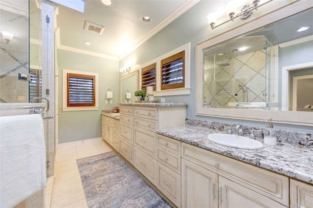 bathroom with tile patterned flooring, vanity, a shower with shower door, and crown molding