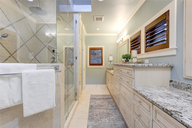 bathroom with tile patterned flooring, vanity, a shower with door, and ornamental molding