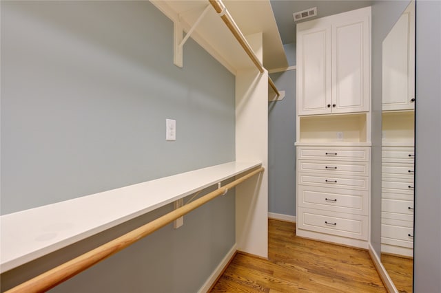 spacious closet featuring light hardwood / wood-style floors