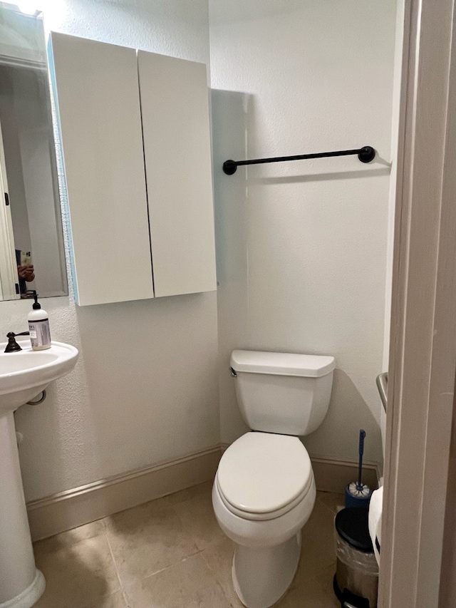 bathroom with tile patterned floors and toilet