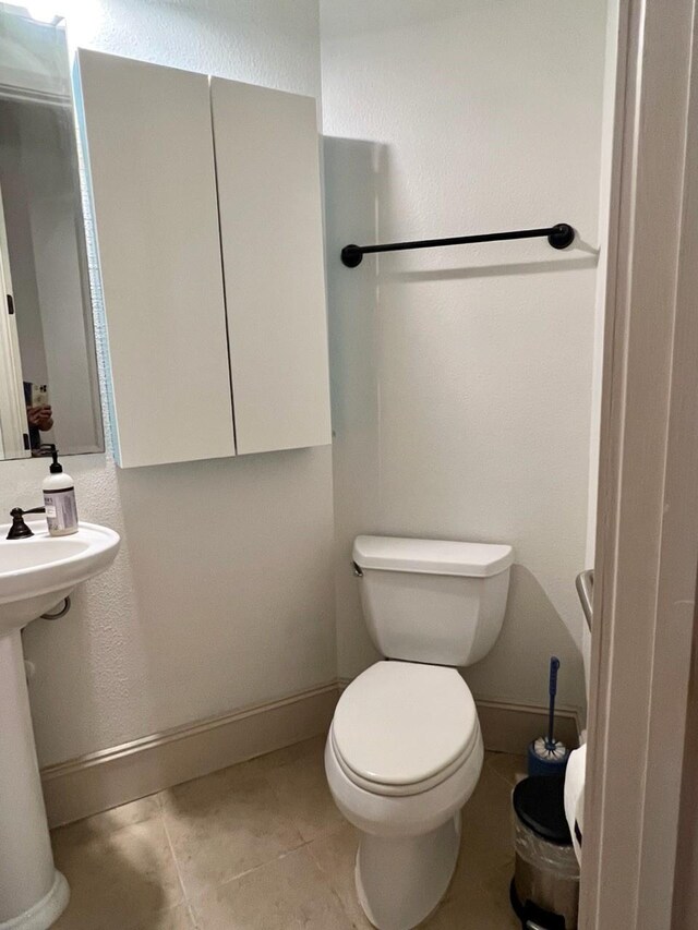 58 Briar Hollow Ln Unit 204, Houston, TX 77027 - half bath with toilet, baseboards, and tile patterned flooring