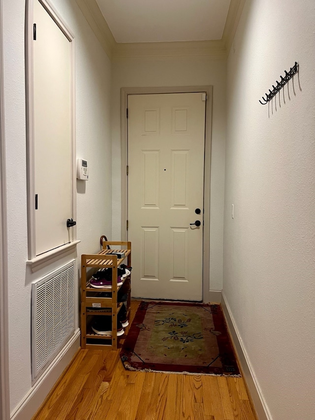 doorway featuring light hardwood / wood-style floors and ornamental molding