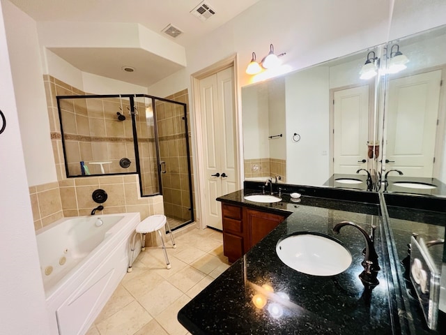 bathroom featuring tile patterned flooring, vanity, and separate shower and tub