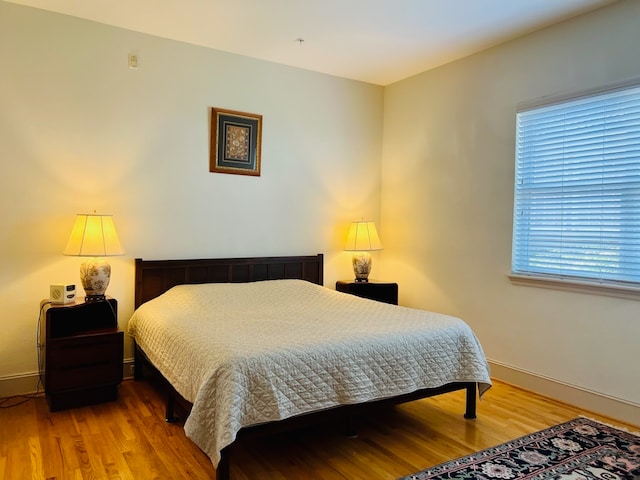 bedroom with hardwood / wood-style floors