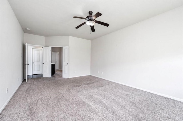 unfurnished bedroom featuring ceiling fan and carpet