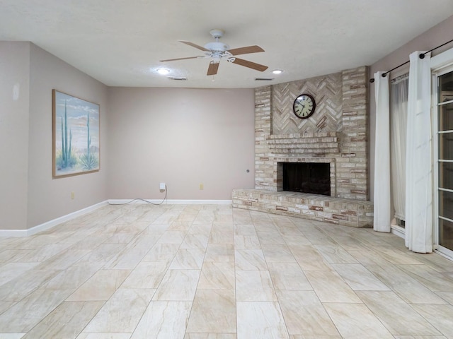 unfurnished living room featuring ceiling fan and a fireplace