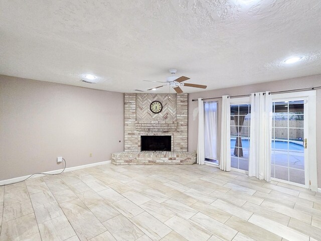 unfurnished living room featuring ceiling fan, a fireplace, and a textured ceiling