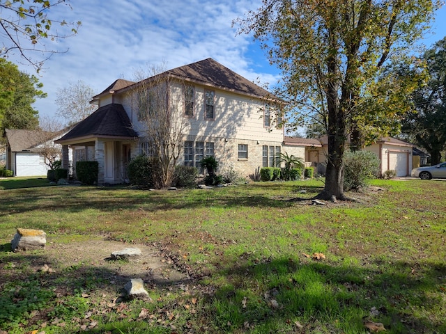 view of front of house with a garage and a front lawn