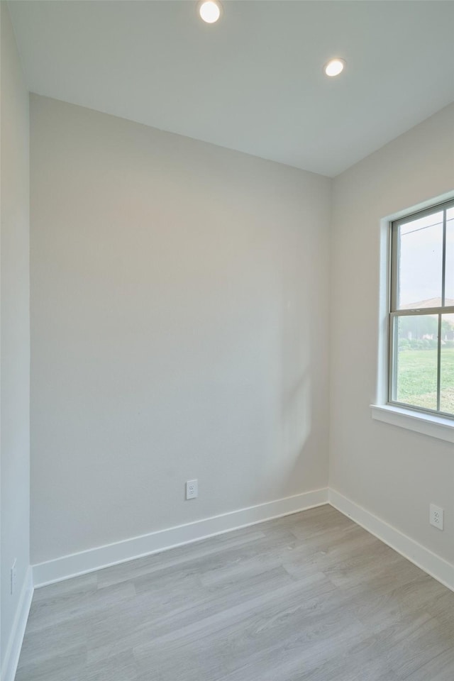 spare room featuring light hardwood / wood-style flooring