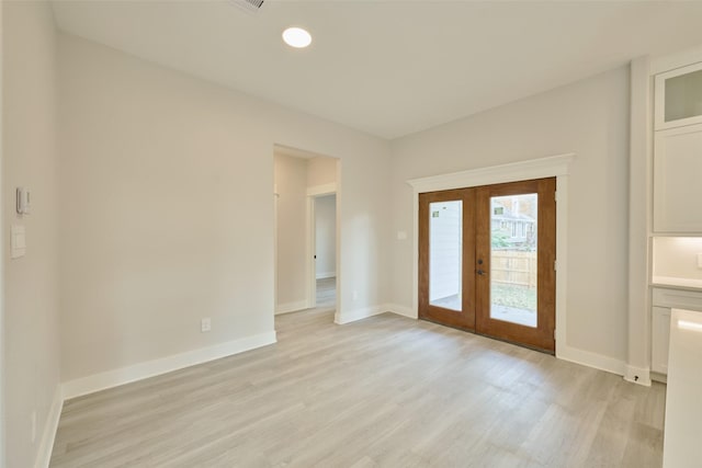 interior space featuring light wood-type flooring and french doors