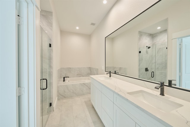 bathroom featuring tile patterned flooring, vanity, and separate shower and tub