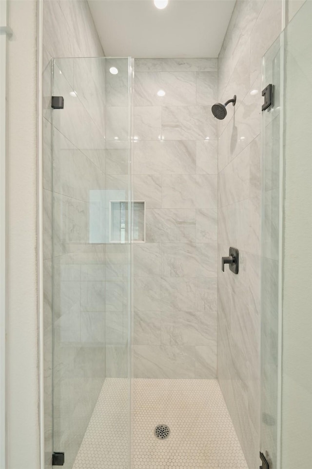 bathroom with a shower with shower door