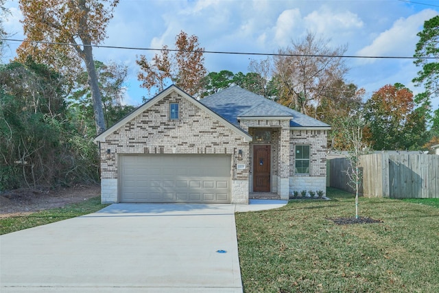 view of front of house featuring a front lawn and a garage