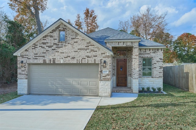 view of front of home with a garage and a front lawn