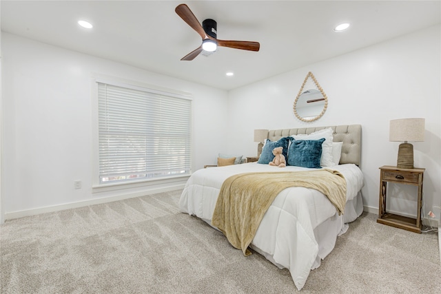 bedroom featuring light colored carpet and ceiling fan