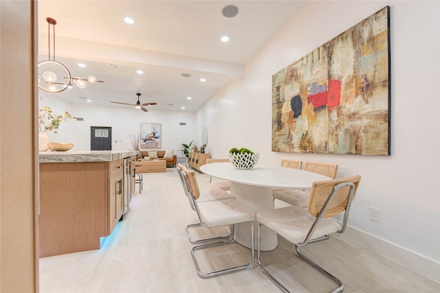 dining room with ceiling fan with notable chandelier and light hardwood / wood-style floors