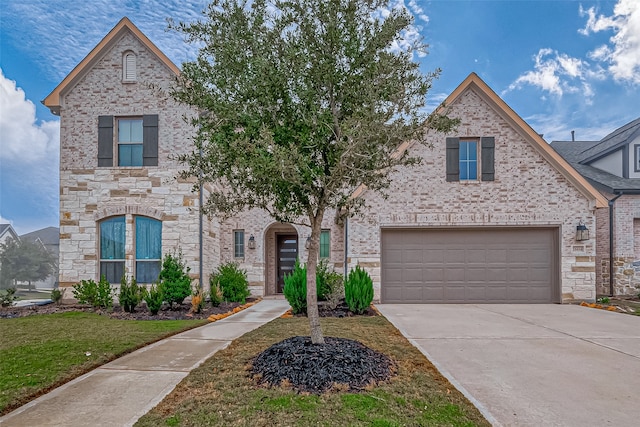 view of front of property featuring a front lawn and a garage