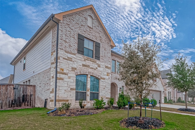 view of front of home featuring a garage and a front yard