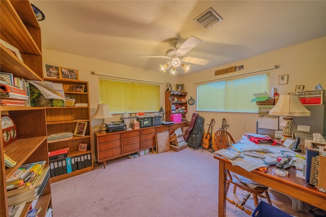 carpeted office space with ceiling fan