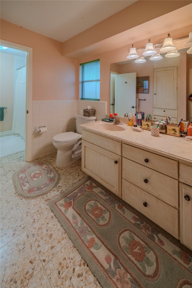 bathroom featuring vanity, tile patterned floors, toilet, tile walls, and curtained shower