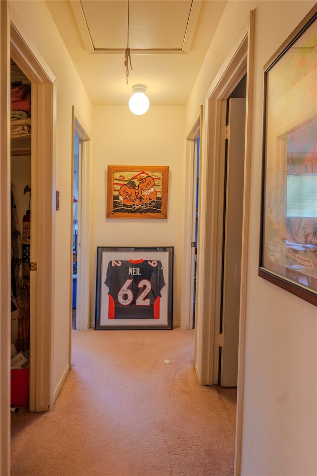 hallway with light colored carpet