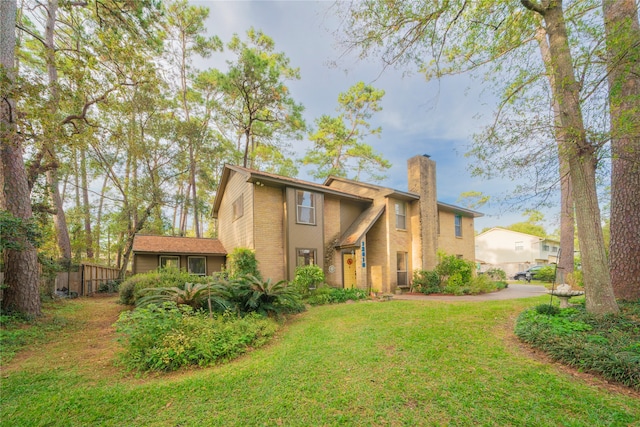 rear view of house with a lawn