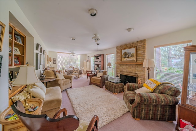 carpeted living room featuring a fireplace and ceiling fan