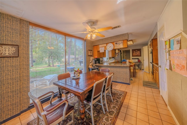 dining room featuring ceiling fan and light tile patterned flooring