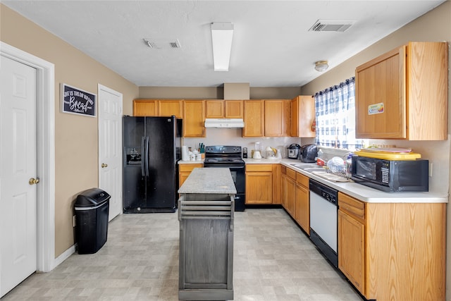 kitchen with light brown cabinetry, a center island, black appliances, and sink