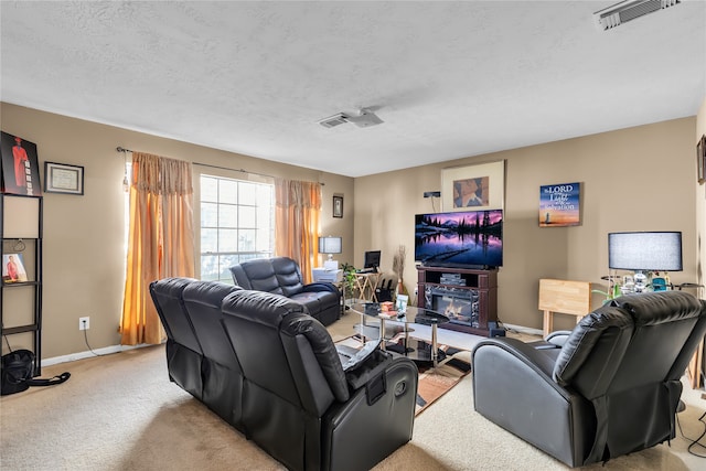 living room featuring a textured ceiling and light colored carpet