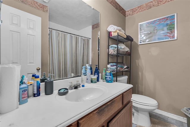 bathroom featuring a shower with curtain, vanity, and toilet