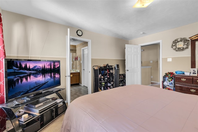 bedroom featuring ensuite bath and carpet floors