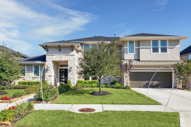 view of front facade featuring a garage and a front lawn