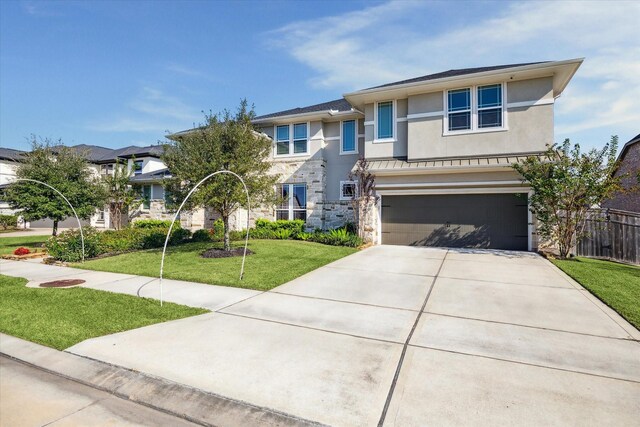 view of front of house featuring a garage and a front yard