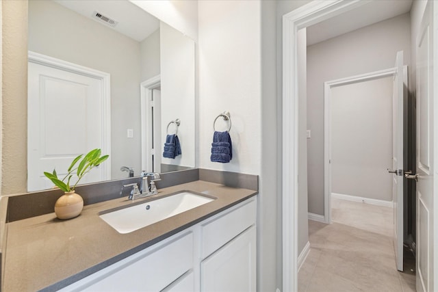 bathroom with baseboards, visible vents, tile patterned flooring, and vanity