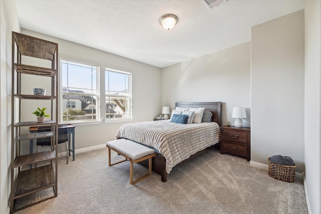 bedroom with carpet, visible vents, and baseboards