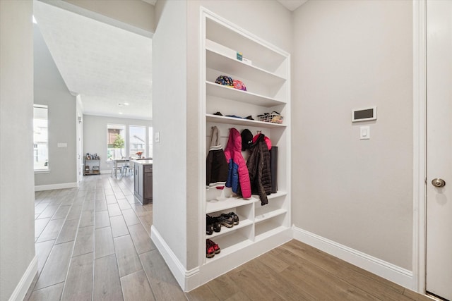 mudroom featuring light wood-type flooring and baseboards