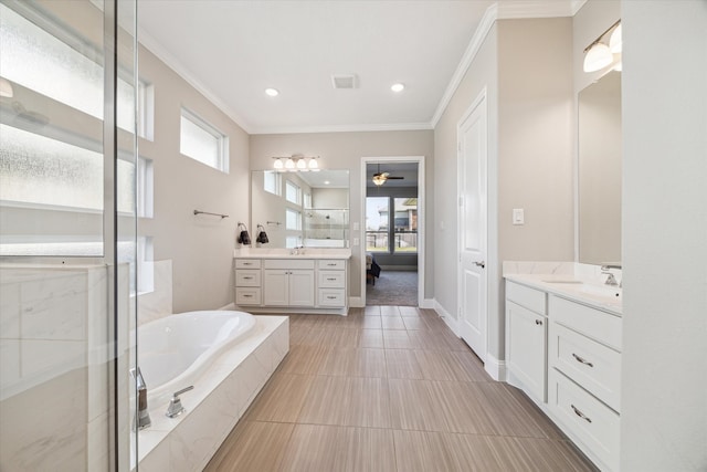 bathroom with tile patterned flooring, vanity, ornamental molding, and a tub to relax in