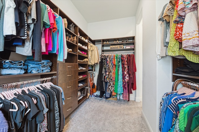 spacious closet featuring light carpet